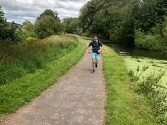 Tom running by the canal.