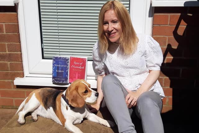 Rachel pictured with her books and her pet dog, beagle Flora