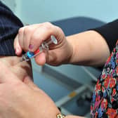 Nurse practitioner Julie Balmer, right, injects Doctor Kate Ardern, as she gets a flu jab to promote campaign to get members of the public vaccinated against the flu virus.