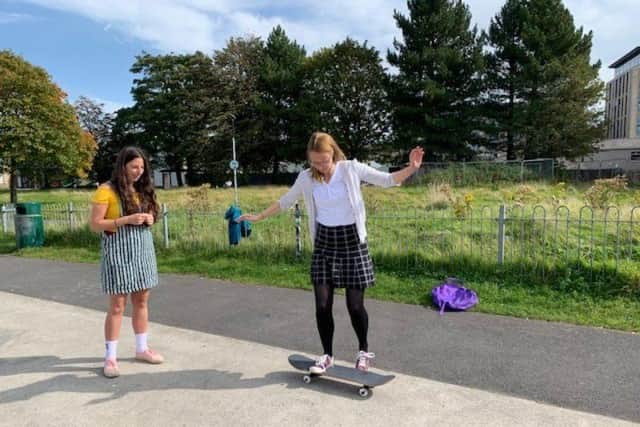 Lancaster MP Cat Smith takes skateboarding instructions from Molly at Lancaster Skatepark.