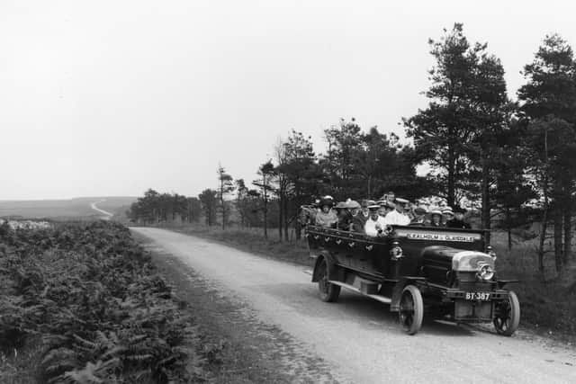 1913:  An early open topped charabanc taking passengers on a trip over the moors, near Whitby, North Yorkshire.  (Photo by Hulton Archive/Getty Images)