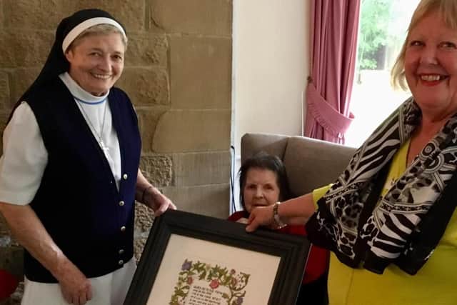 In Nazareth House with a plaque in tribute to Loreto Benson nee Freel.