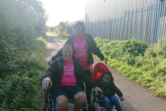 Mark and Paula during the walk with grandson Noah, who went along to give his support with his dad Josh Brandwood.