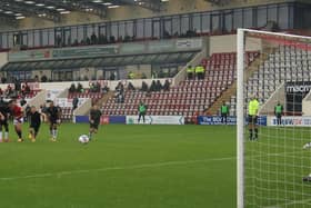 Adam Phillips scores from the spot in Morecambe's win against Port Vale