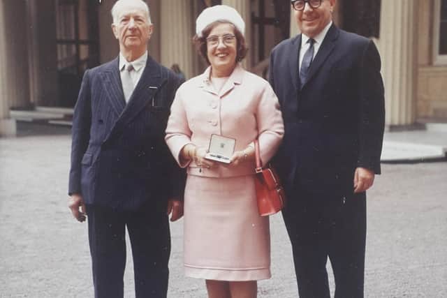 Marjorie Dawson, of Morecambe, receiving her Royal Victorian Medal at Buckingham Palace flanked by her husband, Willoughby Wood Barnard, left, and cousin Eric Knibb