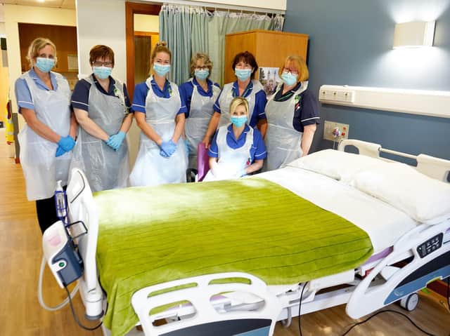 St John's Hospice nurses with the trial cuddle bed.
