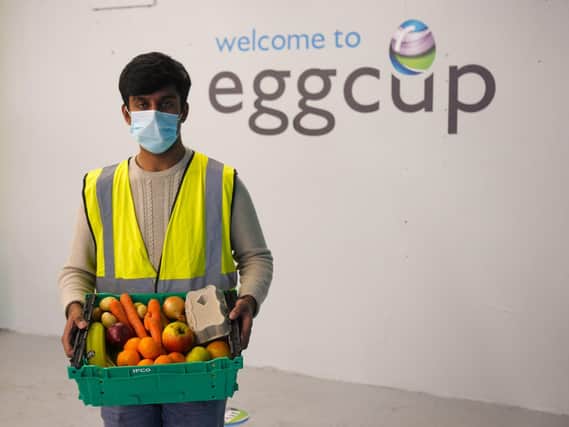 An Eggcup volunteer with some of the local produce.
