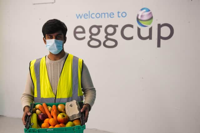 An Eggcup volunteer with one of the midwinter hampers.