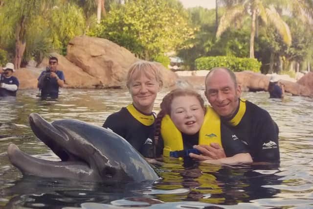Elinor age 12 at Discovery Cove, Florida, with mum Gillian and step-dad Stephan, during a Wish Upon a Star holiday.