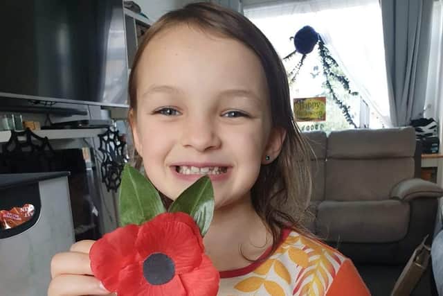 Abigail Myles with one of the poppies she has made to raise money for the Royal British Legion.