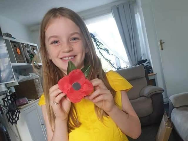 Megan Myles with one of the poppies she made to raise funds for the Royal British Legion.