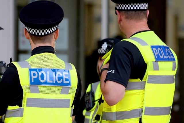 Two off-duty police officers have been praised for their "tremendous bravery" after they restrained a "violent" man in Lancaster.