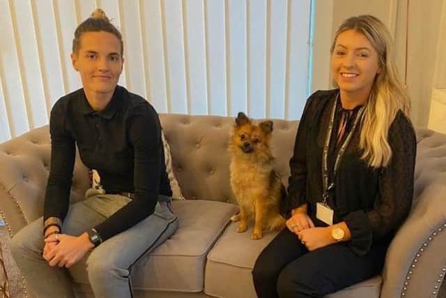 Pictured at the new Lancaster office are (from left) Lucy Trusler, a client coordinator and Christie Parker, care manager. Also pictured is  Lucy's dog, Nala, a welcome visitor to the office.