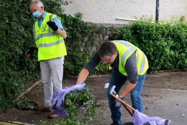 A Carnforth resident (left) and Coun John Reynolds during a community clean in the town.