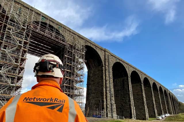 Ribblehead viaduct with Network Rail worker in the foreground