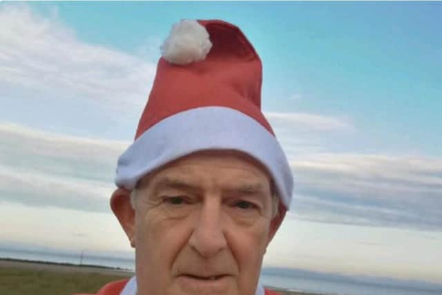 Phill Huddart from Morecambe, who is running along Morecambe promenade and adding a different item of a Santa costume each day.
