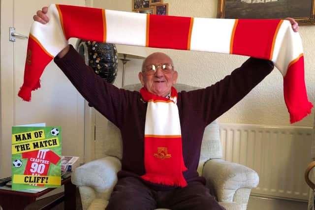 Cliff Crabtree celebrated his 90th birthday with a visit from the Morecambe FC team, who presented him with a signed card, scarf and mug.