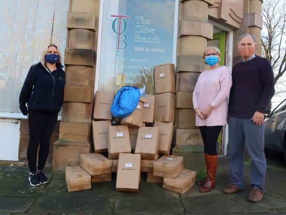 Caddick Construction’s Head of Proposals & Marketing Nicola Jones with The Olive Branch volunteers Marilyn Wadeson and David Barnett taking delivery of the sleeping bags.