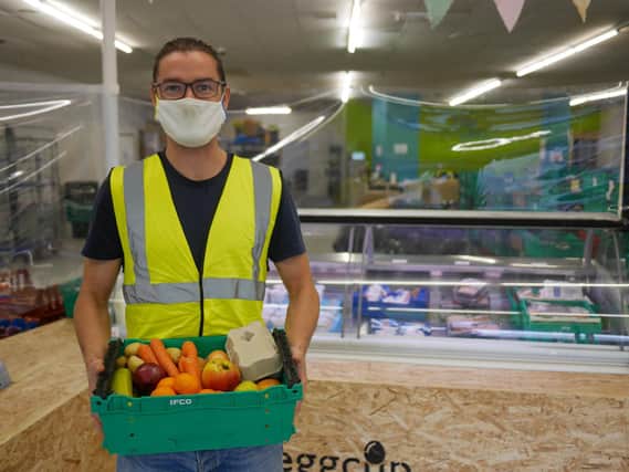 A volunteer packages up fresh produce at the Lancaster city centre food hub. Eggcup is a membership-based alternative to grocery stores.