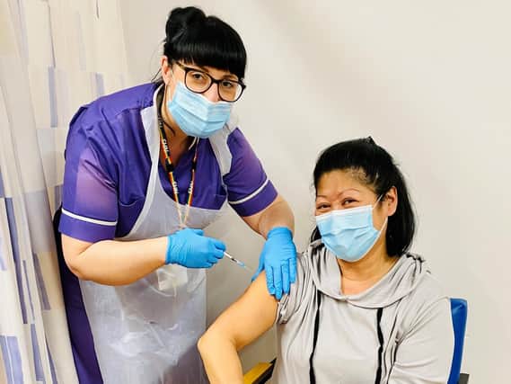 Nurse Jane Brown is given her Covid vaccination by nurse Clare Hill.