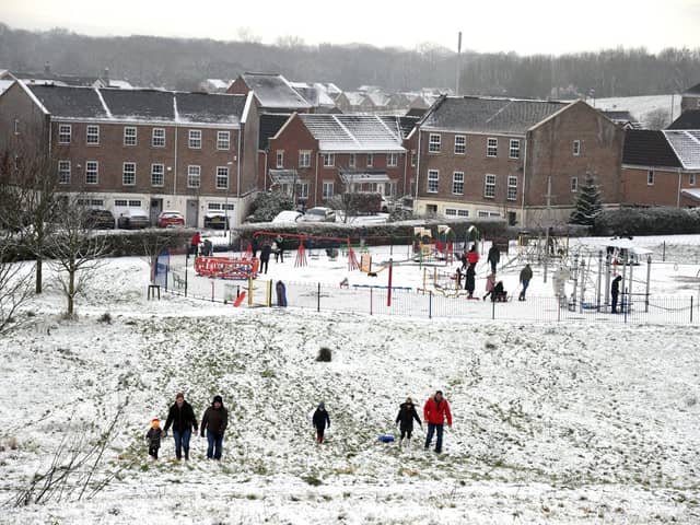 Families enjoy the snow in Buckshaw Village, near Chorley, earlier this week. North West Ambulance Service is urging people to be careful in the ice and snow after a recent spike in calls to the service