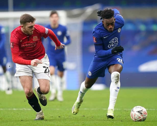 Morecambe's Ryan Cooney (left) and Chelsea's Callum Hudson-Odoi (right) battle for the ball during the Emirates FA Cup third round match at Stamford Bridge