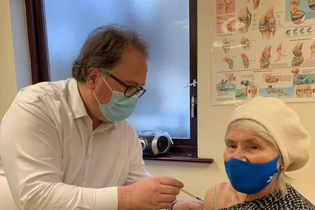 Dr David Wrigley administering a Covid-19 vaccine to a patient at Ash Trees Surgery in Carnforth.