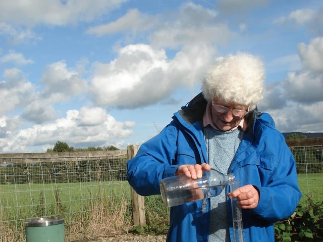 Muriel Lord pictured checking daily rainfall levels