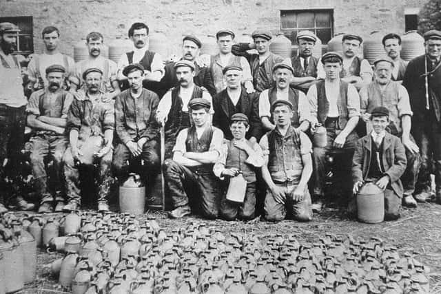 The workers of Waterside Pottery in 1906. Back row from left: Harry Bateson (thrower and owner), Charlie Armer (general worker, night fireman), Jack Fisher (bench hand, day fireman), Bill Fletcher (carter), Jack Lee (wand weaver), Isaac Briscoe (general worker), Arthur Baines (packer), Ted Jones (miner), Sep Lee (thrower), John B Brayshaw (namer and kiln loader), Jack Fletcher (carter). Middle row from left : Bill Standing (fettler and kiln loader), Sam Skeats (engine driver), Jim Brayshaw (jnr) (turner, day fireman), Squire Taylor (wand weaver mainly, but could do any job in the pottery), Jim Brayshaw (snr) (wand weaver), Teddy Tomlinson (miner), Christopher Isaac Briscoe (naming, kiln loader, night fireman), Dixon Bateson (general worker). Front row from left: Charlie Brayshaw (bench hand, taker off), Richard T Bateson (this was the year before Richard began work), Gordon Taylor (general worker), Harold Bateson (jam jar maker). Richard Bateson is in the front row with his hand covering his neck. Apparently