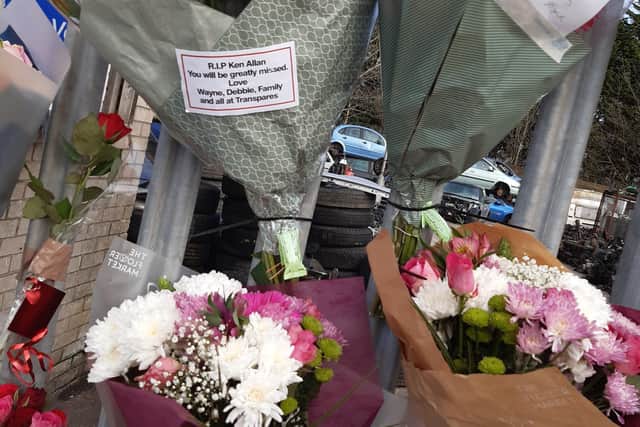 Floral tributes outside Ken Allen Auto Wreckers on Monday.