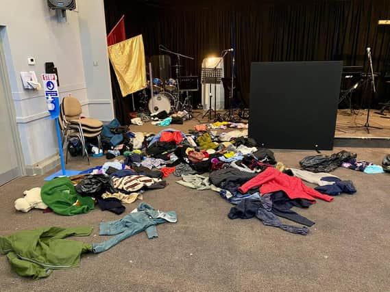 Clothes for the homeless left strewn across the floor after a break-in at Father's House in Lancaster.