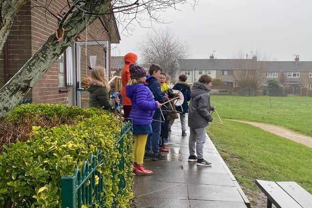 Youngsters at St Wilfrid's gather outside to 'make some noise' in a bid to bring the community together.