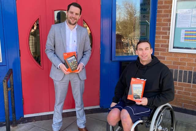 Rob Smith, headteacher at Mossgate Primary School in Heysham, with Shaun Gash and some of the tablets he has bought through his fundraising campaign.