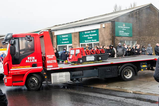 One of Ken Allen's trucks joins the funeral cortege, carrying a floral tribute from the firm. Photo by Kelvin Stuttard
