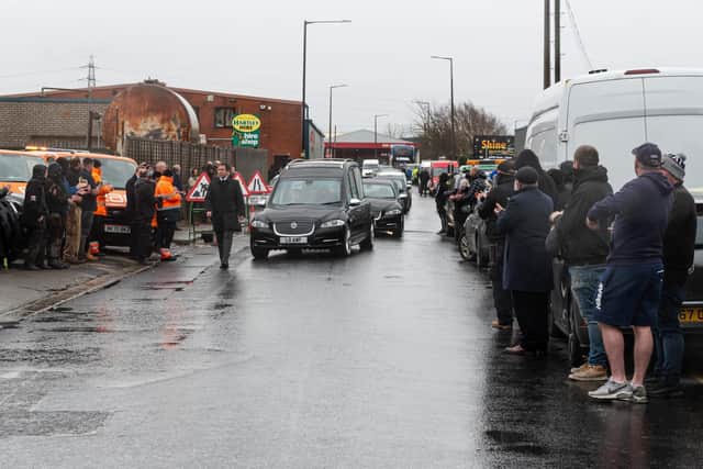 Crowds gather as Ken Allen's funeral cortege passes by his business on White Lund. Photo by Kelvin Stuttard
