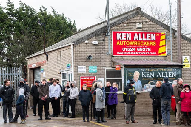 Crowds gather to applaud Ken Allen's funeral cortege as it passes by his business on White Lund. Photo by Kelvin Stuttard