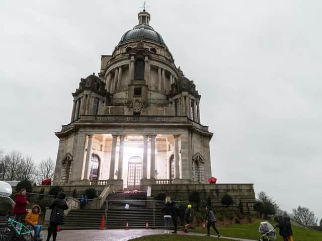 Passers-by brave the rain to check out the filming of Peaky Blinders in the Ashton Memorial. Photo by Kelvin Stuttard