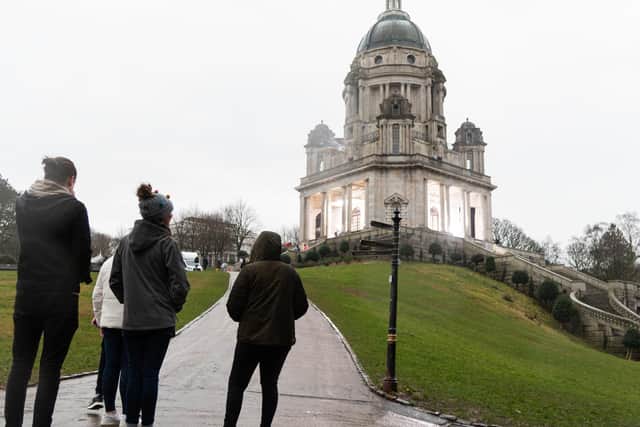 Passers-by brave the rain to check out the filming of Peaky Blinders in the Ashton Memorial. Photo by Kelvin Stuttard