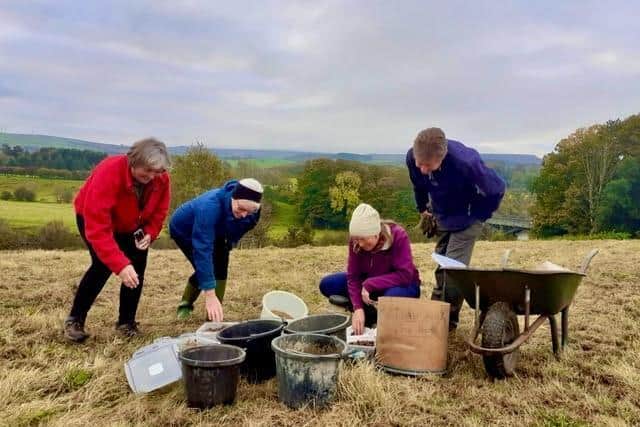 Mixing seeds for planting at the site near the Crook O' Lune. Photo taken pre-Covid.