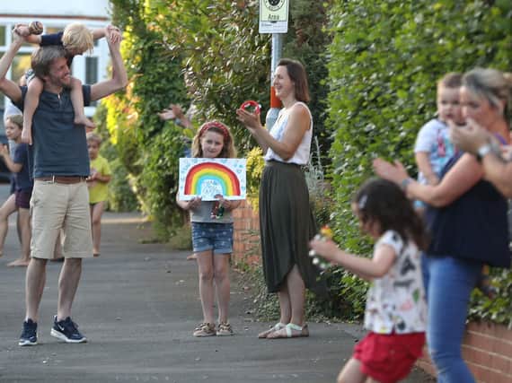 Families take part in a clap for the NHS held during the first lockdown in 2020.