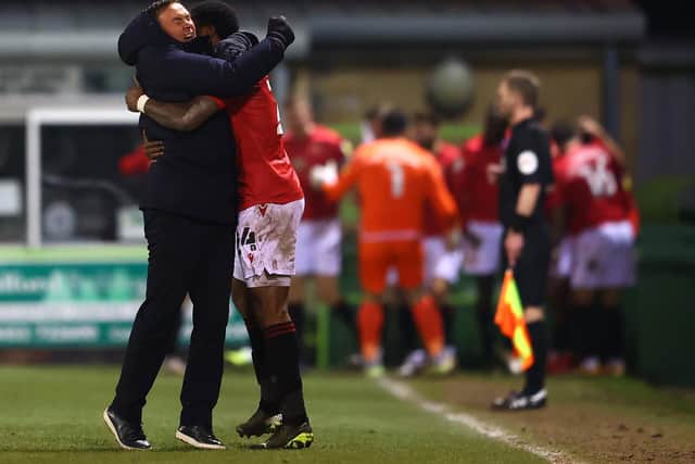 Derek Adams and Yann Songo'o celebrate Morecambe's late equaliser at Forest Green Rovers