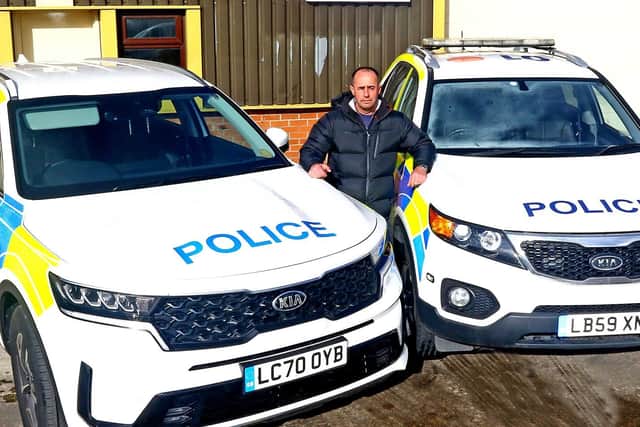 Lights, camera, action... Kris Holt with two of his police cars. Picture by Tony North