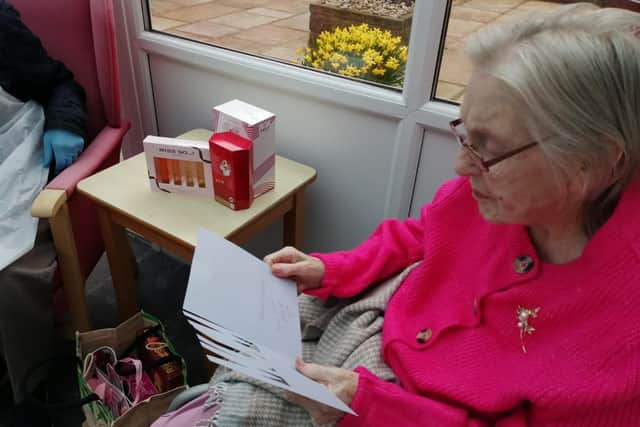 Joan Russell opens her Mother's Day presents and cards.