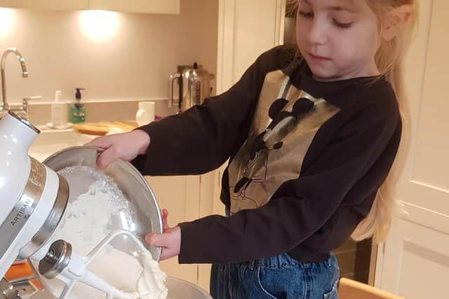 Amira Ratcliffe baking cakes which she sold to raise money for St John's Hospice.