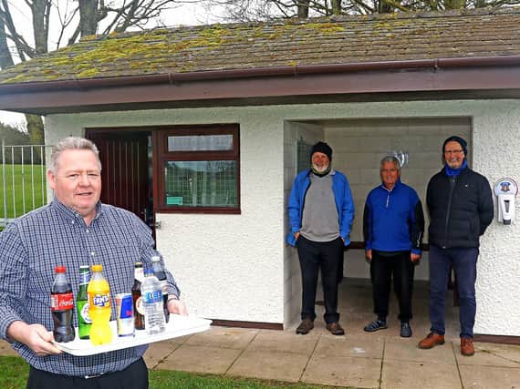 Andy McMillan outside the halfway house. Watching on are John Feather, Roy Barker and David Wright, three of the volunteers who helped renovate the building. Photo by Tony North