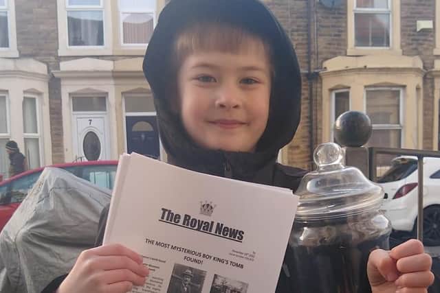 Javier Shaw collecting money for charity by selling his newspaper.