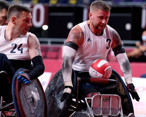 Britain's Stuart Robinson (R), a veteran who was wounded in Afghanistan, rolls to score during the pool phase group B wheelchair rugby match between Britain and Canada during the Tokyo 2020 Paralympic Games at the Yoyogi National Stadium in Tokyo on August 25, 2021. (Photo by Behrouz MEHRI / AFP) (Photo by BEHROUZ MEHRI/AFP via Getty Images)