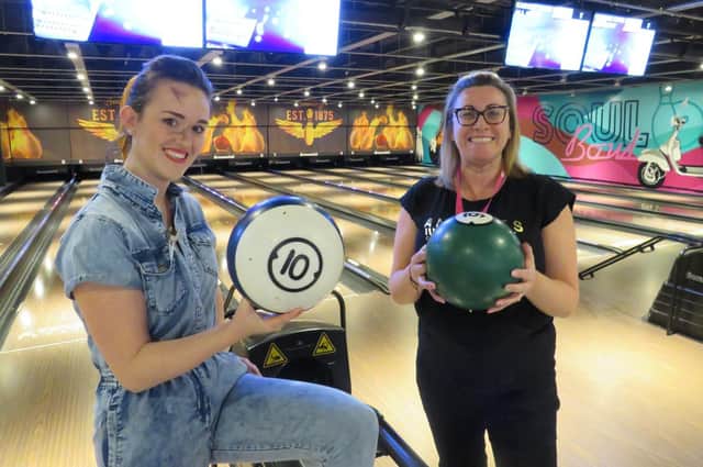 CancerCare director of fundraising Emma Athersmith (right) with a competitor at the 2020 bowling event.