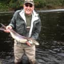 Brian James with a wild salmon prior to its release back in the water