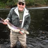 Brian James with a wild salmon prior to its release back in the water